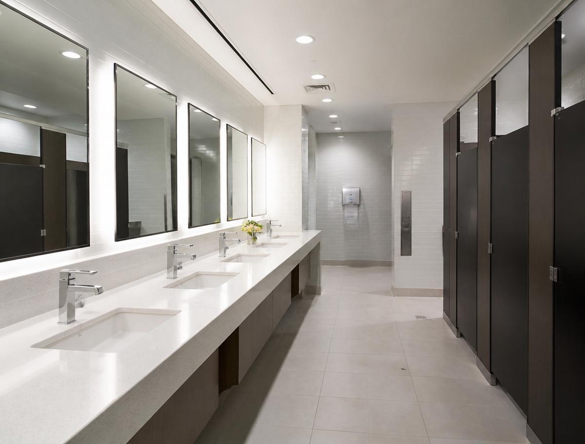 Sparkling clean commercial restroom sink and mirror after sanitizing service